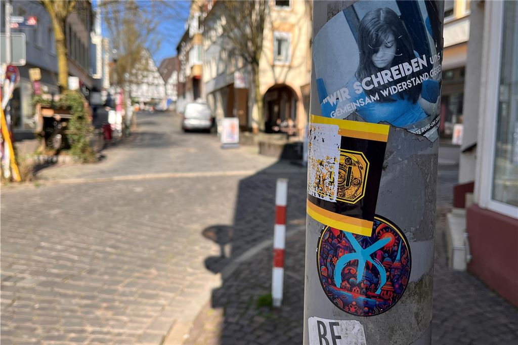 An einem Laternenmast in Unna kleben verschiedene Aufkleber