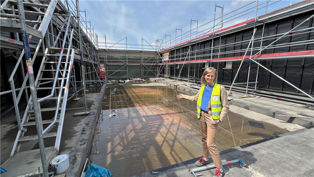 Neuer Bildungsstandort: In einem Jahr sollen die Arbeiten fertig sein Olga Goßmann vom städtischen Immobilienmanagement steht vor einer Einlassung, die künftig als "grünes Klassenzimmer" genutzt werden soll.