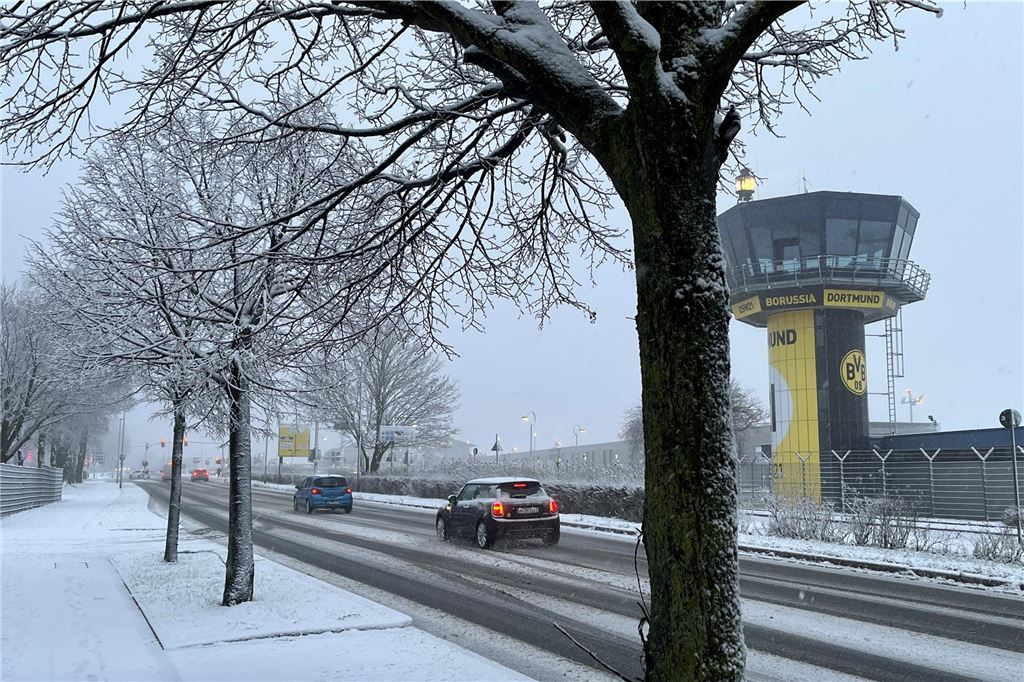 Der Kontrollturm des Dortmunder Flughafens mit den schwarz-gelben Vereinsfarben des BVB kommt durch den Schnee noch besser zur Geltung.