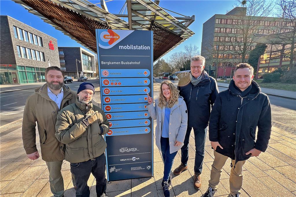 Bergkamen ist mit erster Mobilstation kreisweit Vorreiter Jens Toschläger (Beigeordneter Bergkamen), Manuel Schumacher (Grafik-Agentur), Carina Steffens (Mobilitätsmanagerin Bergkamen), Bernd Schäfer (Bürgermeister Bergkamen) und Norman Raupach (Stabsstelle Klimaschutz Bergkamen) (v.l.) neben dem neuen Schild, das die erste Mobilstation des Kreis Unna am Busbahnhof Bergkamen kennzeichnet.