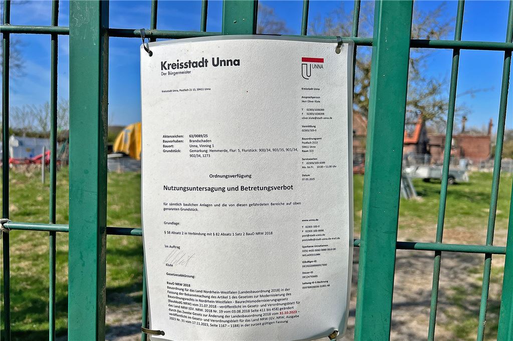 Bewohner des abgebrannten Bauernhofs war öfter im Visier der Behörden Ein Zettel der Kreisstadt Unna hängt an einem grünen Zaun