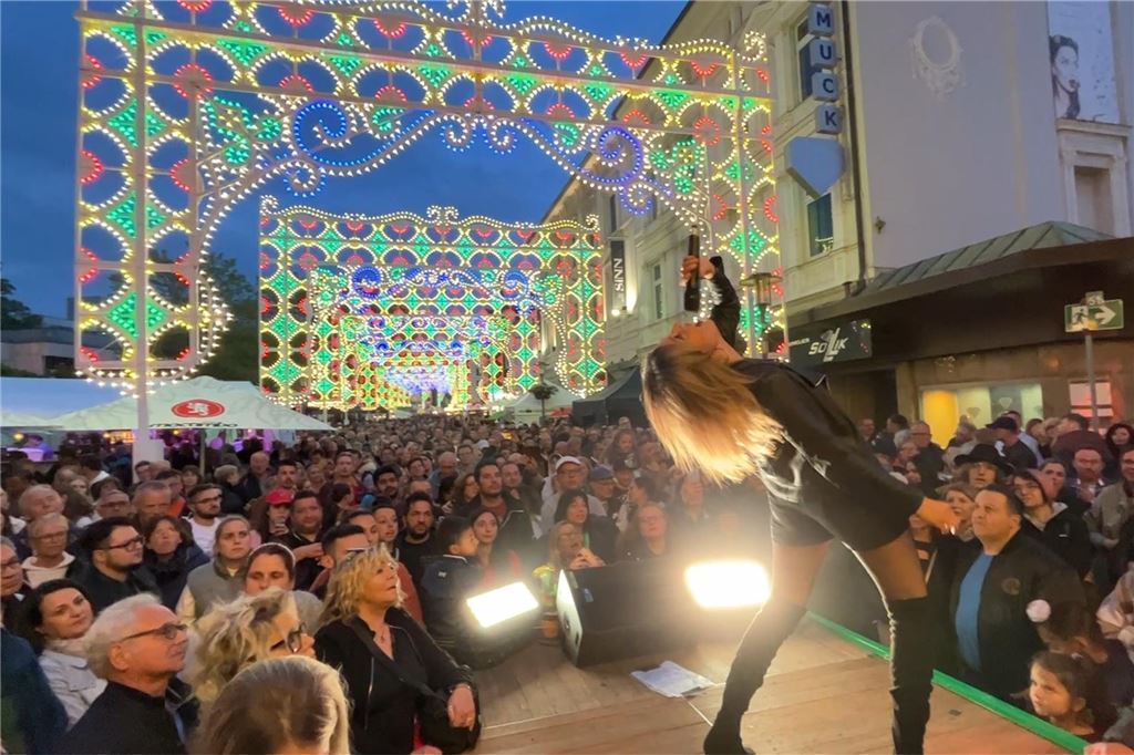 Tausende feiern endlich wieder Festa-“Wahnsinn“ Ein Fest für Augen und Ohren: Die Sängerin der "Da Capo Band" gab auf der Bühne am Rathaus alles. Im Hintergrund tauchten die kunstvollen Lichtinstallationen ein Menschenmeer in buntes Licht.