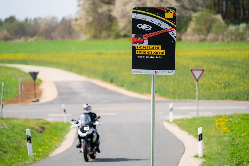 Die Polizei im Kreis Unna kontrolliert Pkw-Lärm anders als Motorradlärm Ein Motorradfahrer fährt an einem Schild mit der Aufschrift „Leise fahren. Lärm ersparen!“ vorbei.