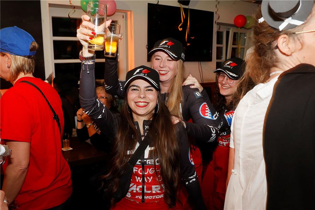 Zwei Frauen prosten mit je einem Bier in Richtung Kamera.